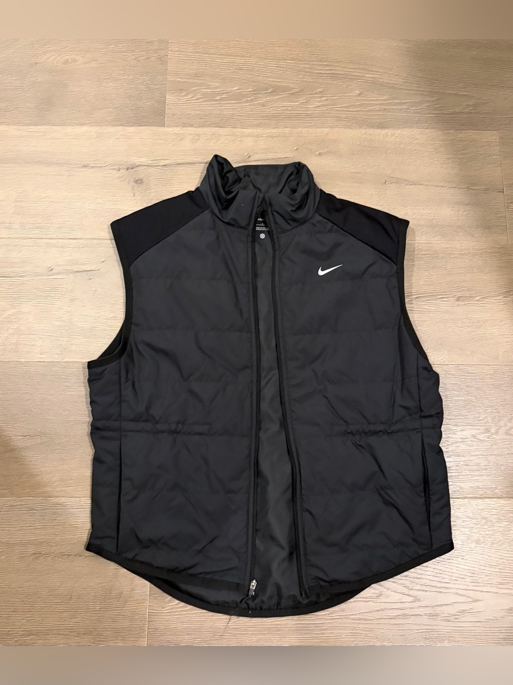 Nike women’s Black Quilted Vest with White Swoosh